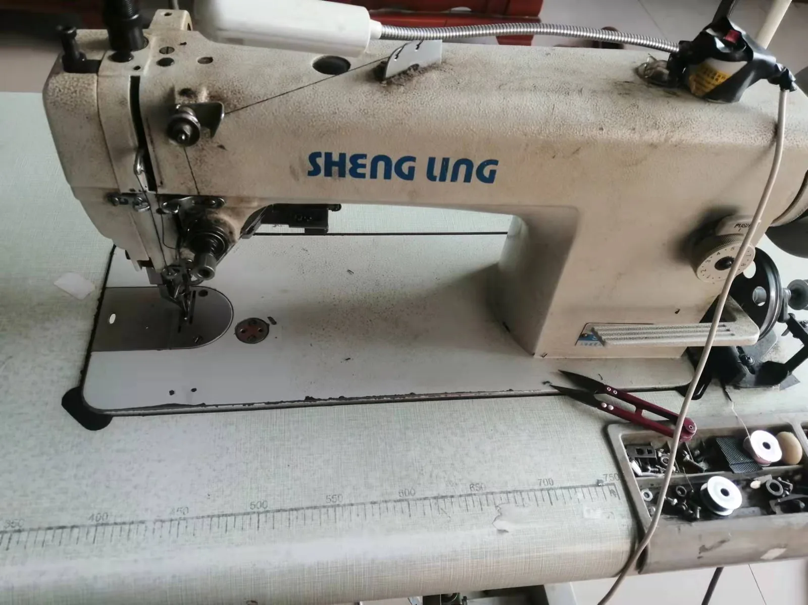 Close-up of an industrial sewing machine