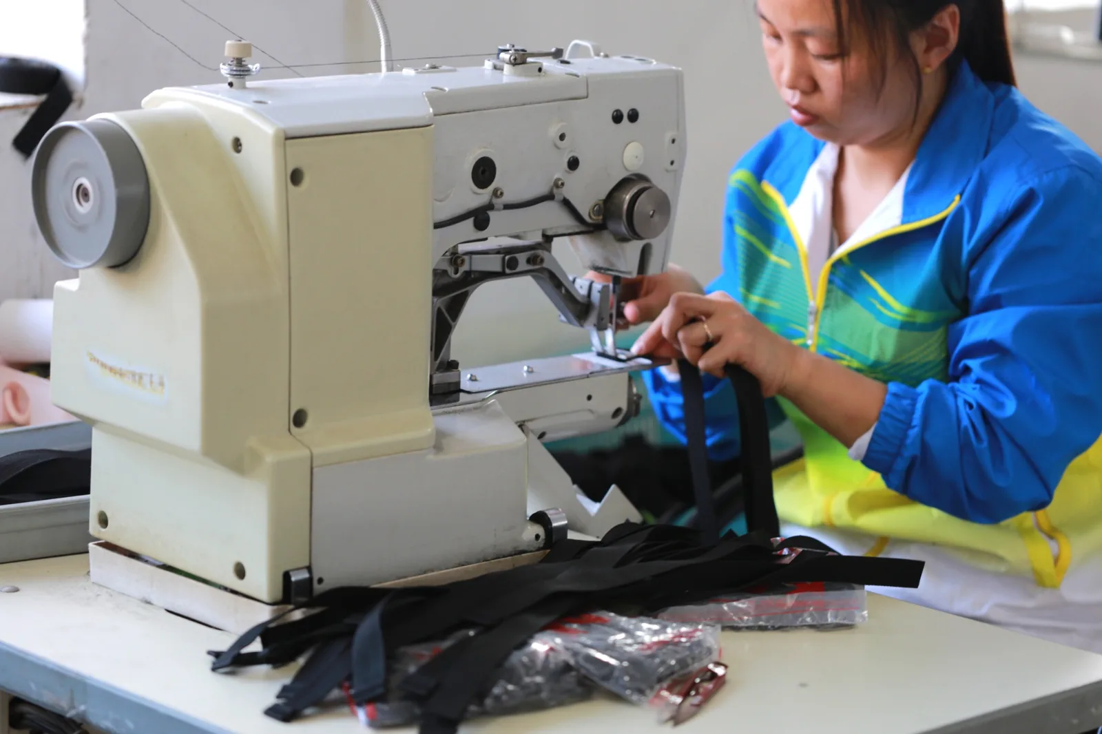 Worker sewing a bag in the workshop